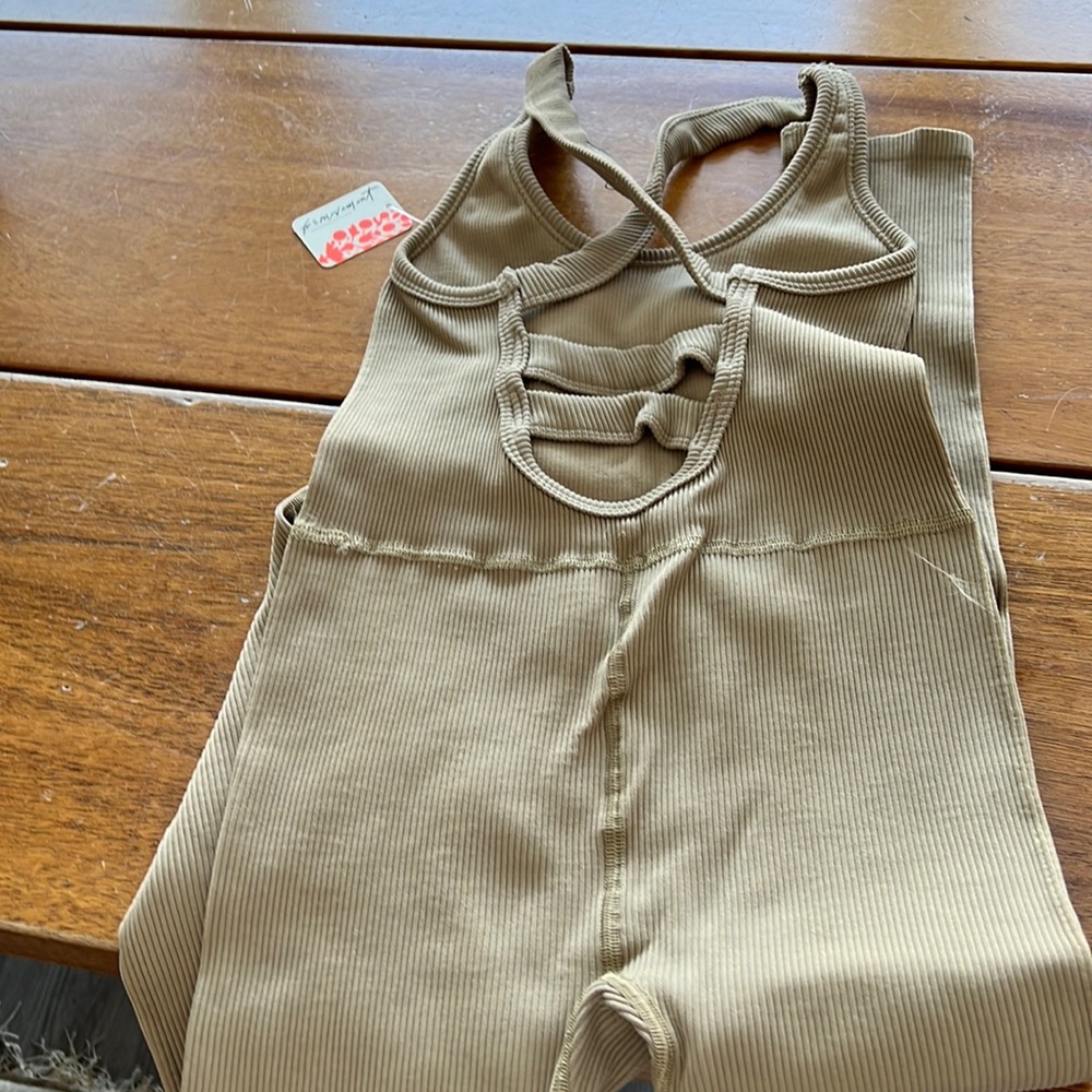 Selling body suit from Free people .